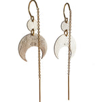 Pair of silver crescent moon earrings with gold chains on a white background