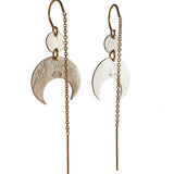 Pair of silver crescent moon earrings with gold chains on a white background