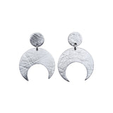 Pair of Sterling Silver Lunar stud earrings on a white background. These earrings feature a textured crescent moon design.