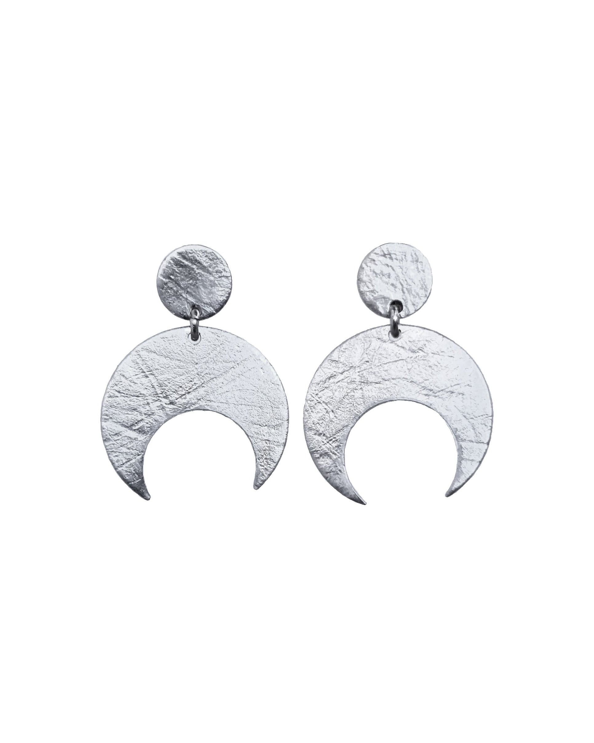 Pair of Sterling Silver Lunar stud earrings on a white background. These earrings feature a textured crescent moon design.