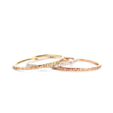 The Trinity Stack Rings, showing how they are three separate rings, on a white background. These rings are a combo of Yellow Gold, Sterling Silver, and Rose Gold, and have a textured organic finish.