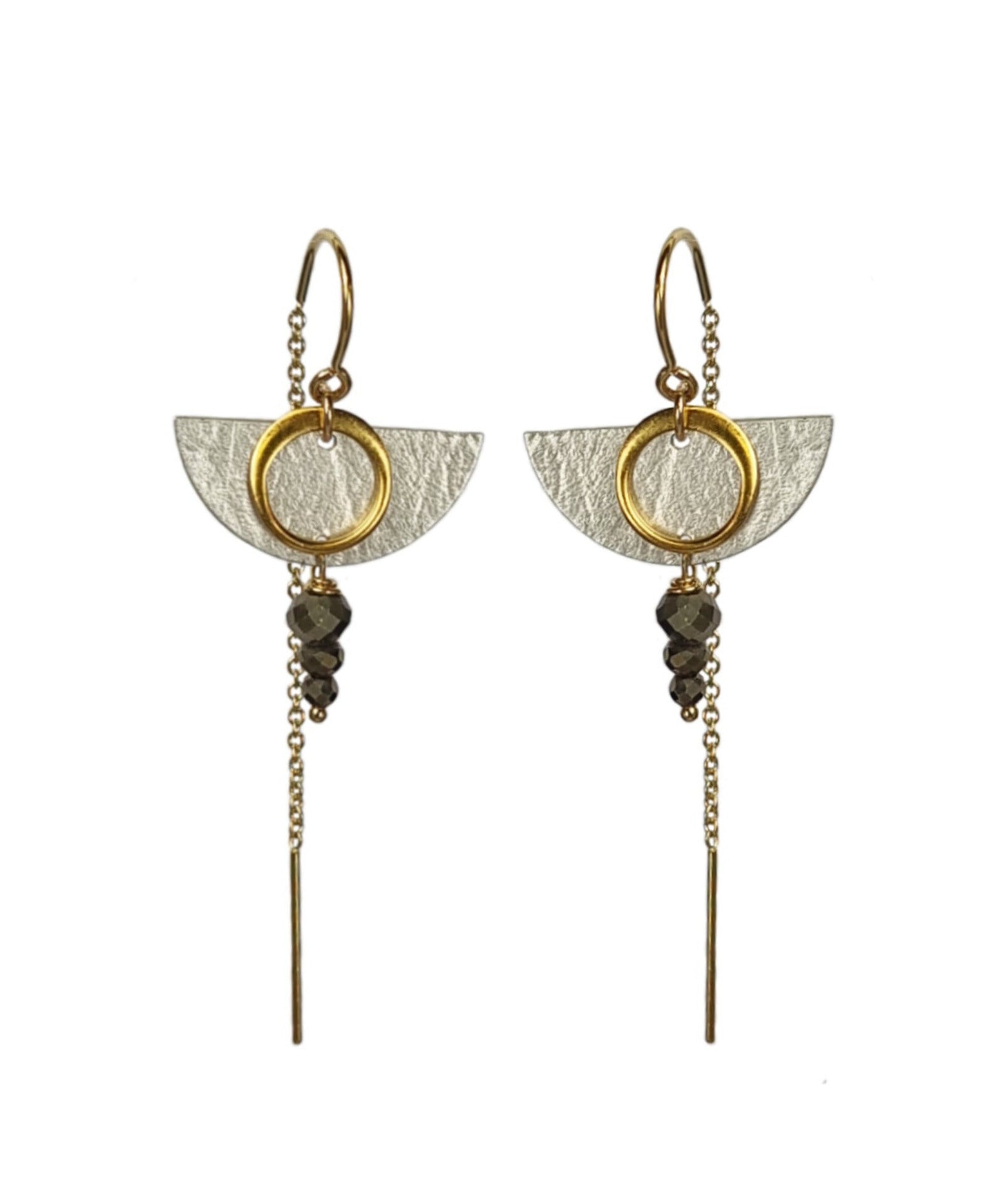 Pair of gold and silver earrings on a white background
