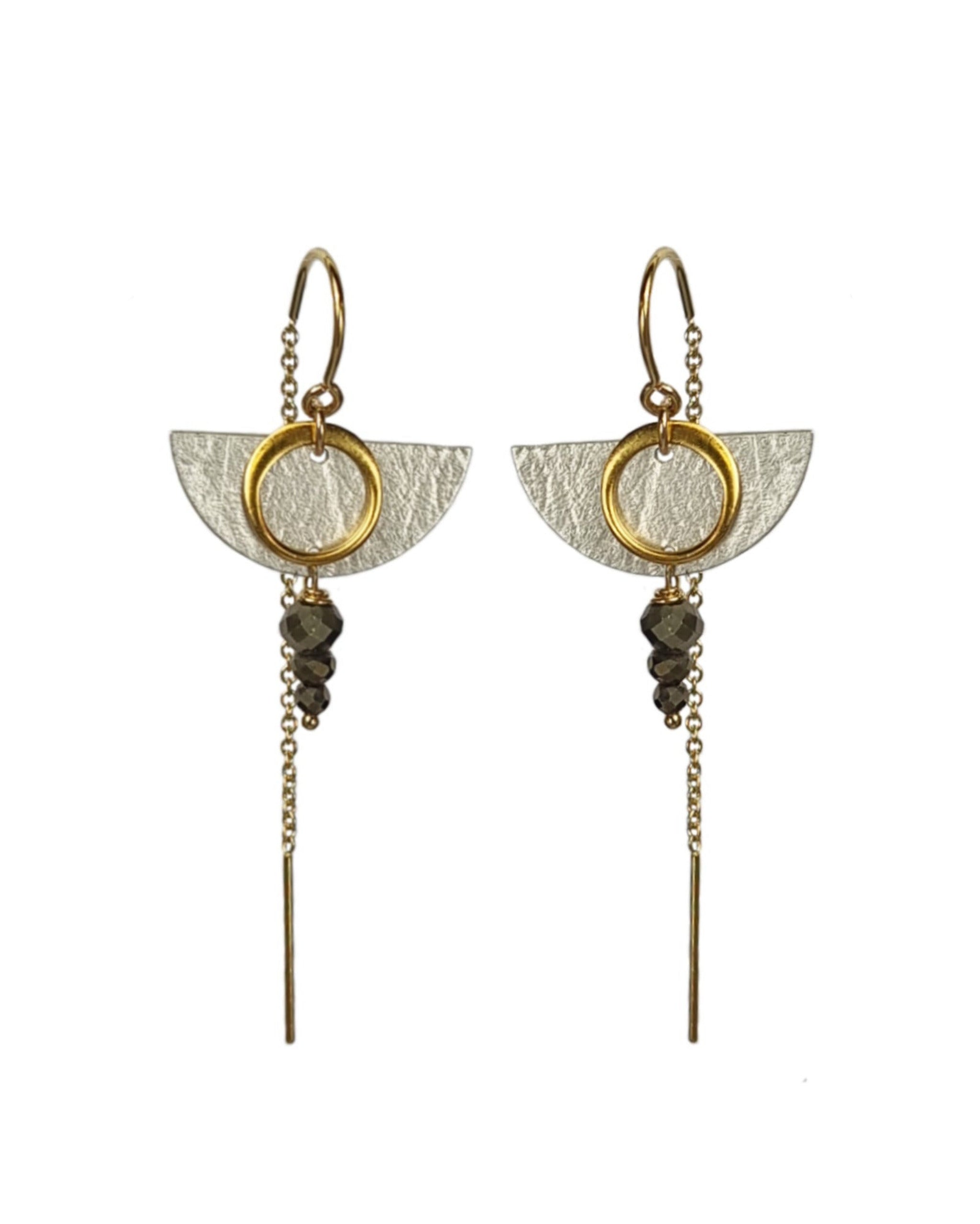 Pair of gold and silver earrings on a white background