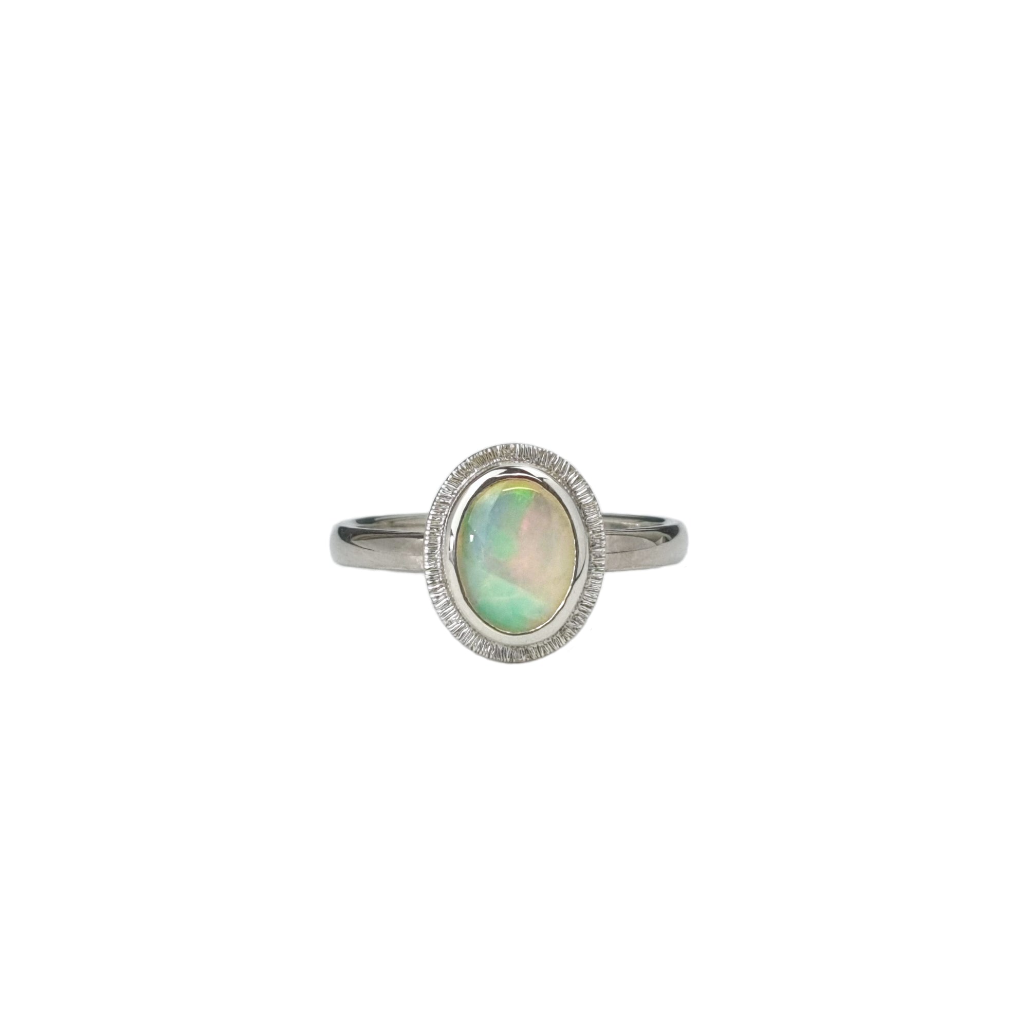 The Silver Aura Stained Glass Opal Silver Ring on a white background, featuring a unique Crystal Opal with vibrant colours, reminiscent of a stained-glass window, set in a Sterling Silver band