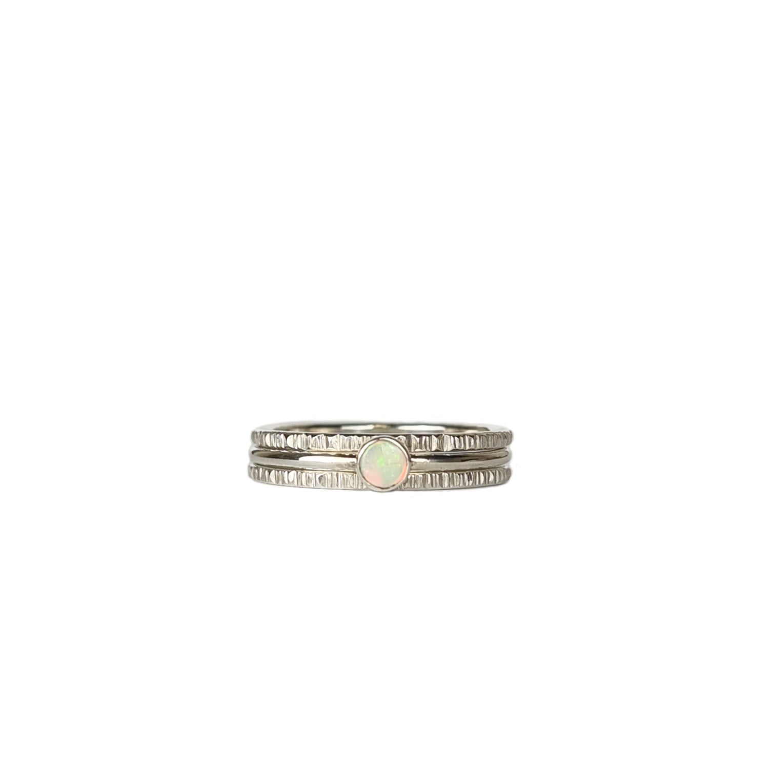 Crystal Opal Silver Stack Ring Set on a white background, featuring three 1.5mm stack rings—two with a textured finish and one with a vibrant Australian Crystal Opal.