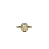 Close-up of Aura Gold Oval Crystal Opal Ring displayed on a white background, showcasing the opal's unique transparency, ethereal quality, and the kaleidoscope of colours reflecting from the gold setting