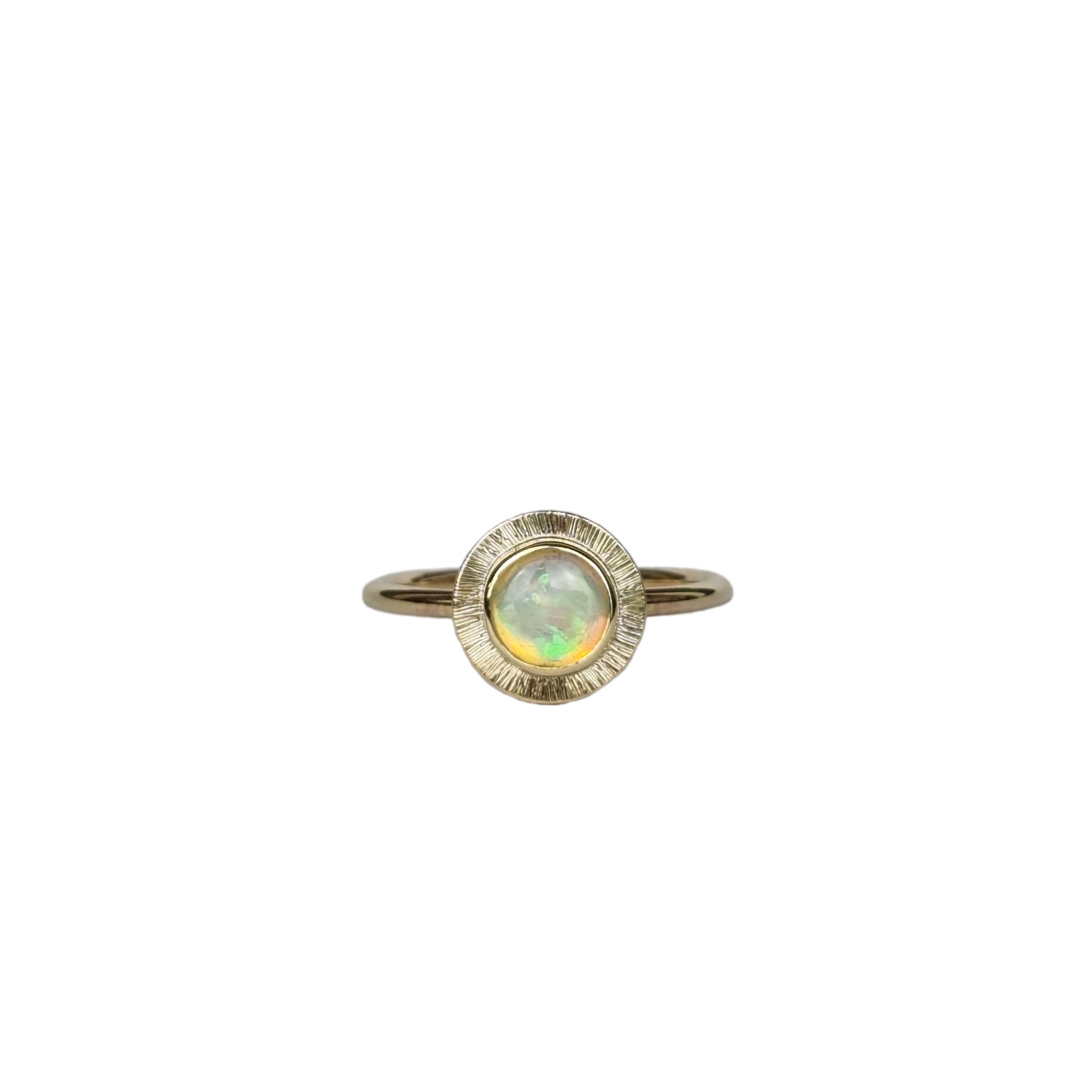 A gold ring featuring a multi-coloured Australian Crystal Opal set in a radiant gold engraved setting