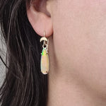 Close-up of Crystal Opal Moon Drop Earrings worn by a model, highlighting the opals' unique play of color and handcrafted design in Sterling Silver and Gold
