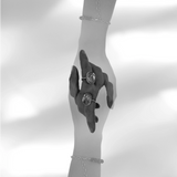 Black and white double exposure image of a hand wearing a Quartz Prescience Ring handmade by Emily Eliza Arlotte. Photo by Cassie Sullivan.