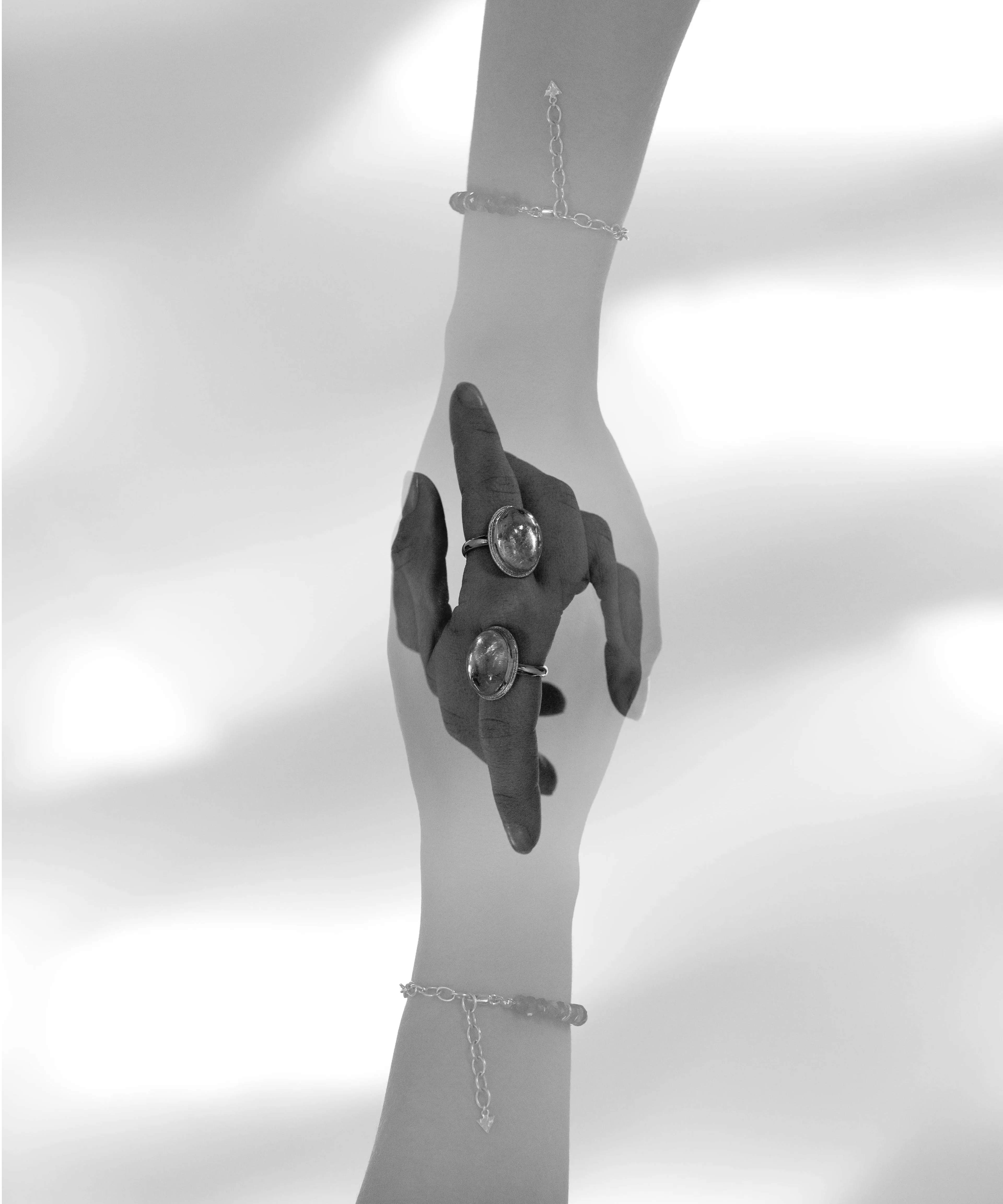 Black and white double exposure image of a hand wearing a Quartz Prescience Ring handmade by Emily Eliza Arlotte. Photo by Cassie Sullivan.