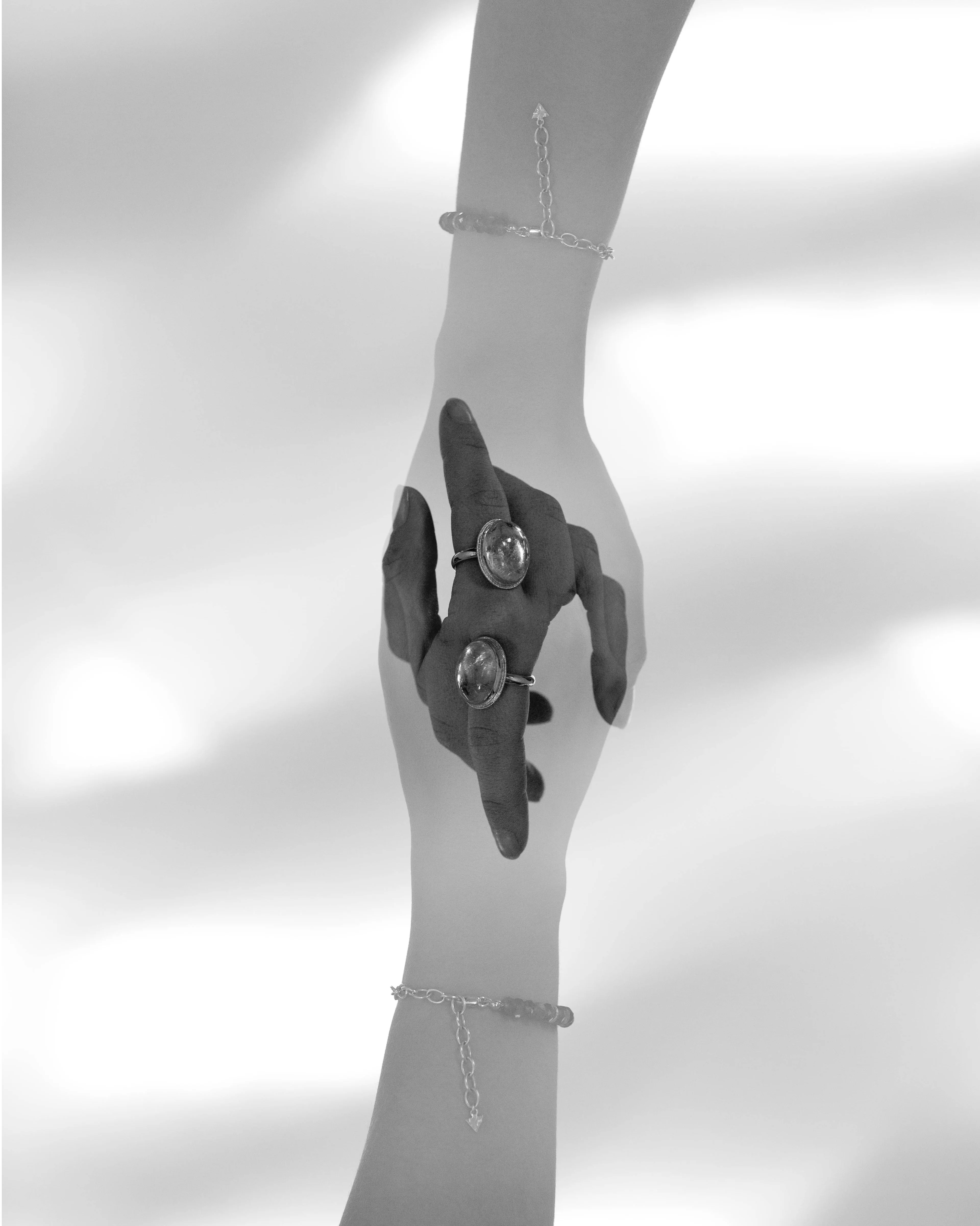 Black and white double exposure image of a hand wearing a Quartz Prescience Ring handmade by Emily Eliza Arlotte. Photo by Cassie Sullivan.