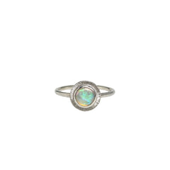 A handmade sterling silver ring featuring an Australian Crystal Opal from Coober Pedy. The opal features pinks, greens, and blue swirls of colour and is set in a radiant engraved silver setting.