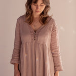 A person wearing a linen pink dress stands facing downwards, wearing the Venus Hoop Earrings and Divination Necklace, both handmade in Hobart Tasmania by Emily Eliza Arlotte.