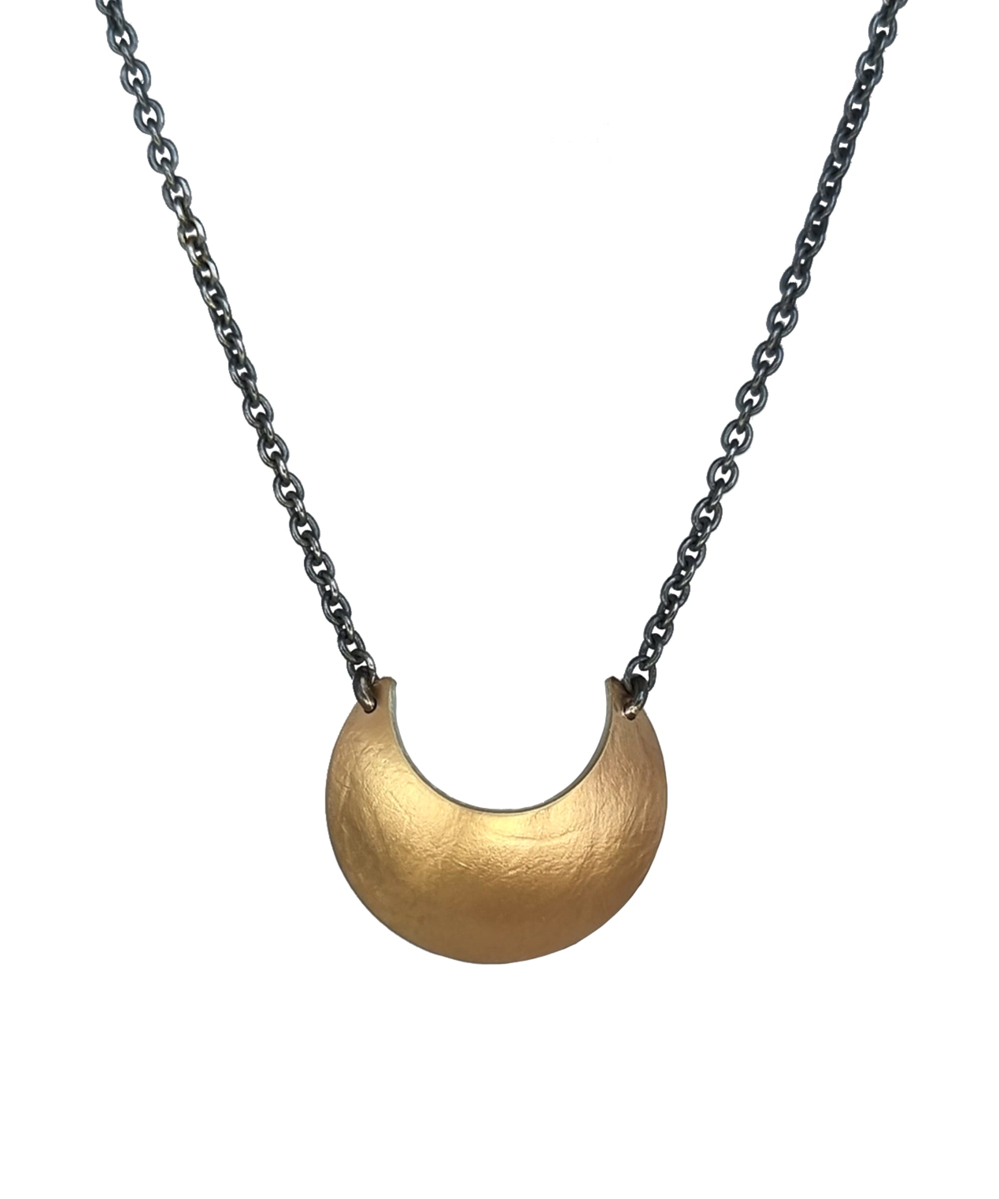Gold Luna Crescens necklace, by Emily Elizza Arlotte, featuring a crescent moon on a black chain against a white background.