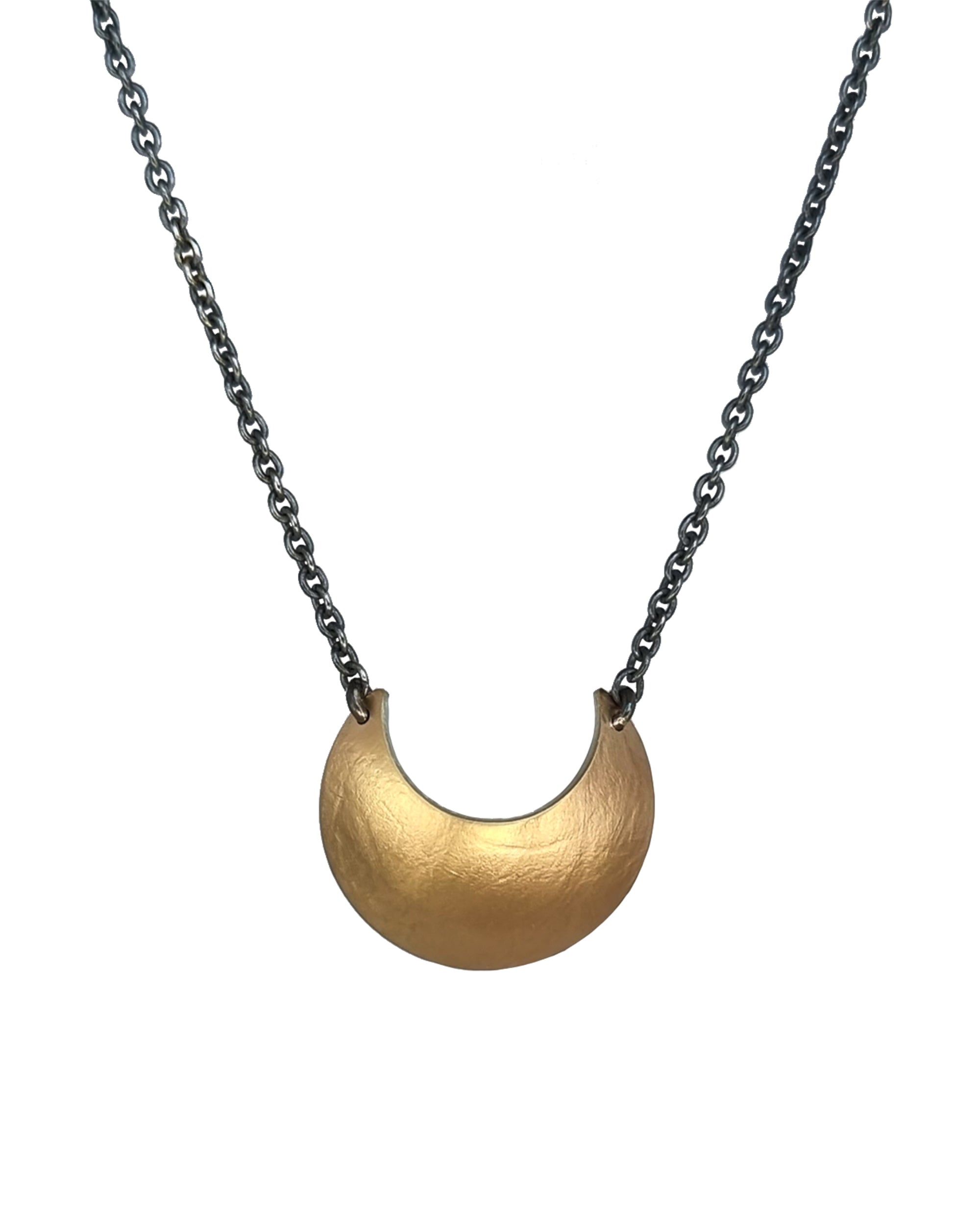 Gold Luna Crescens necklace, by Emily Elizza Arlotte, featuring a crescent moon on a black chain against a white background.