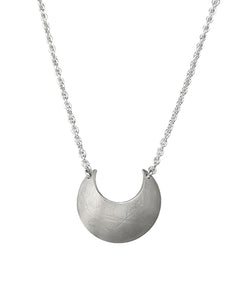 Sterling Silver Luna Crescens necklace featuring a crescent moon on a white background