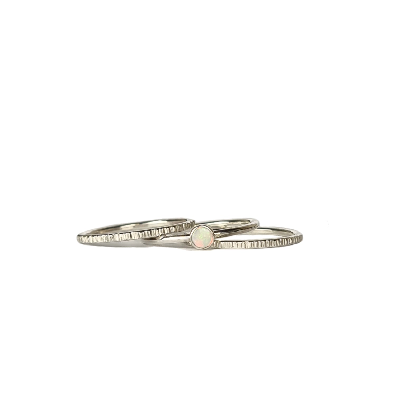 Three-piece Crystal Opal Silver Stack Ring Set displayed on a white background, highlighting the unique transparency and kaleidoscope of colours of the Australian Crystal Opal