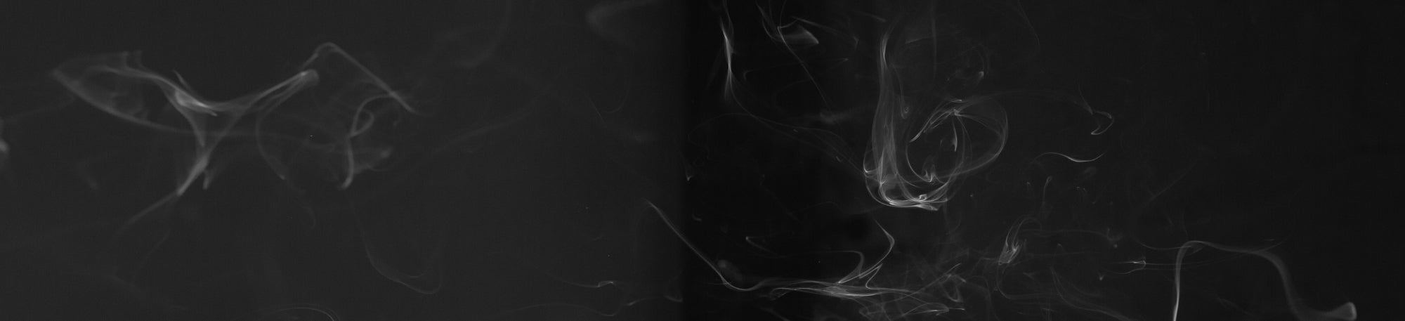 Abstract black and white smoke-like design on a dark background