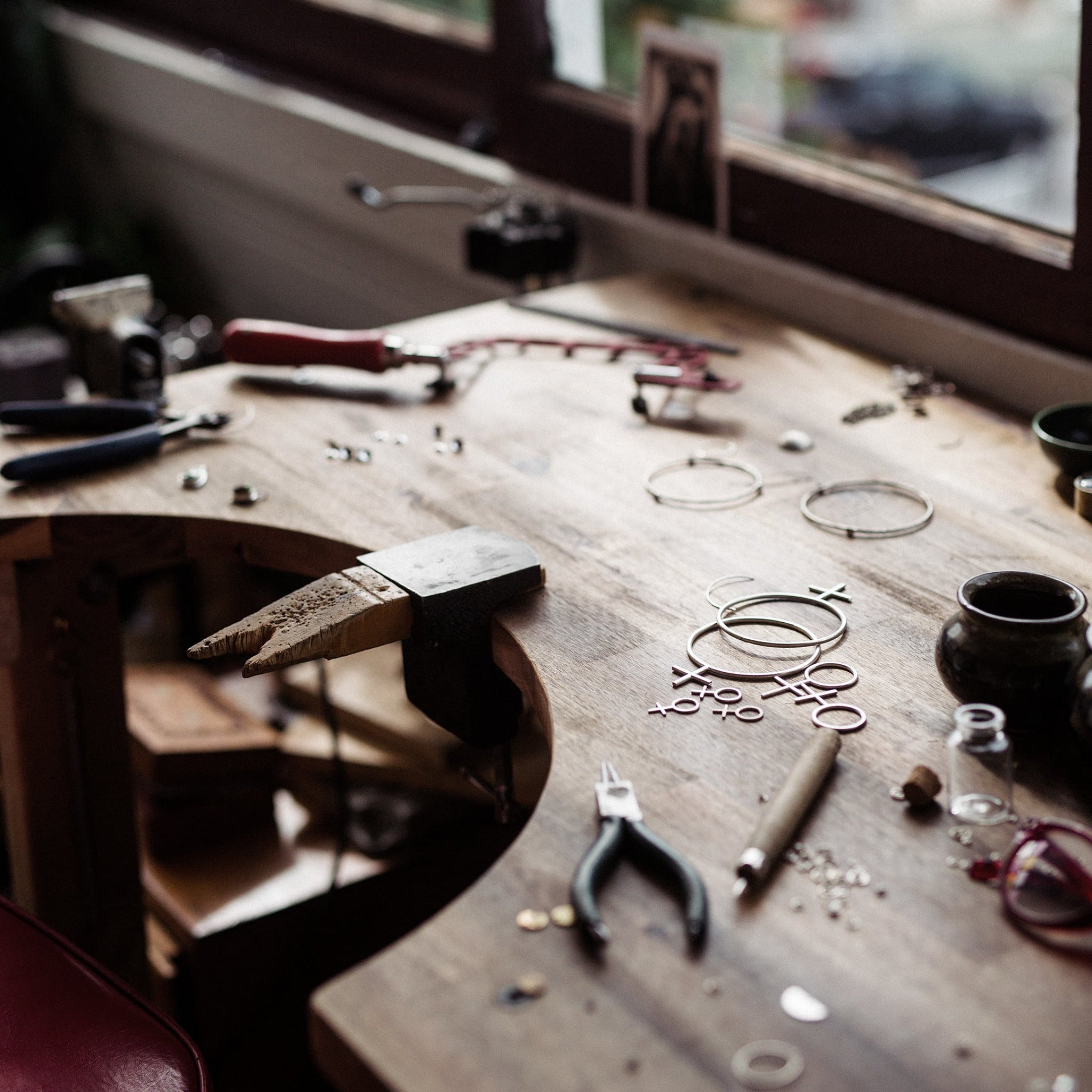 Emily Eliza Arlotte jeweller studio work bench, shown with half created pieces and various tools. 
