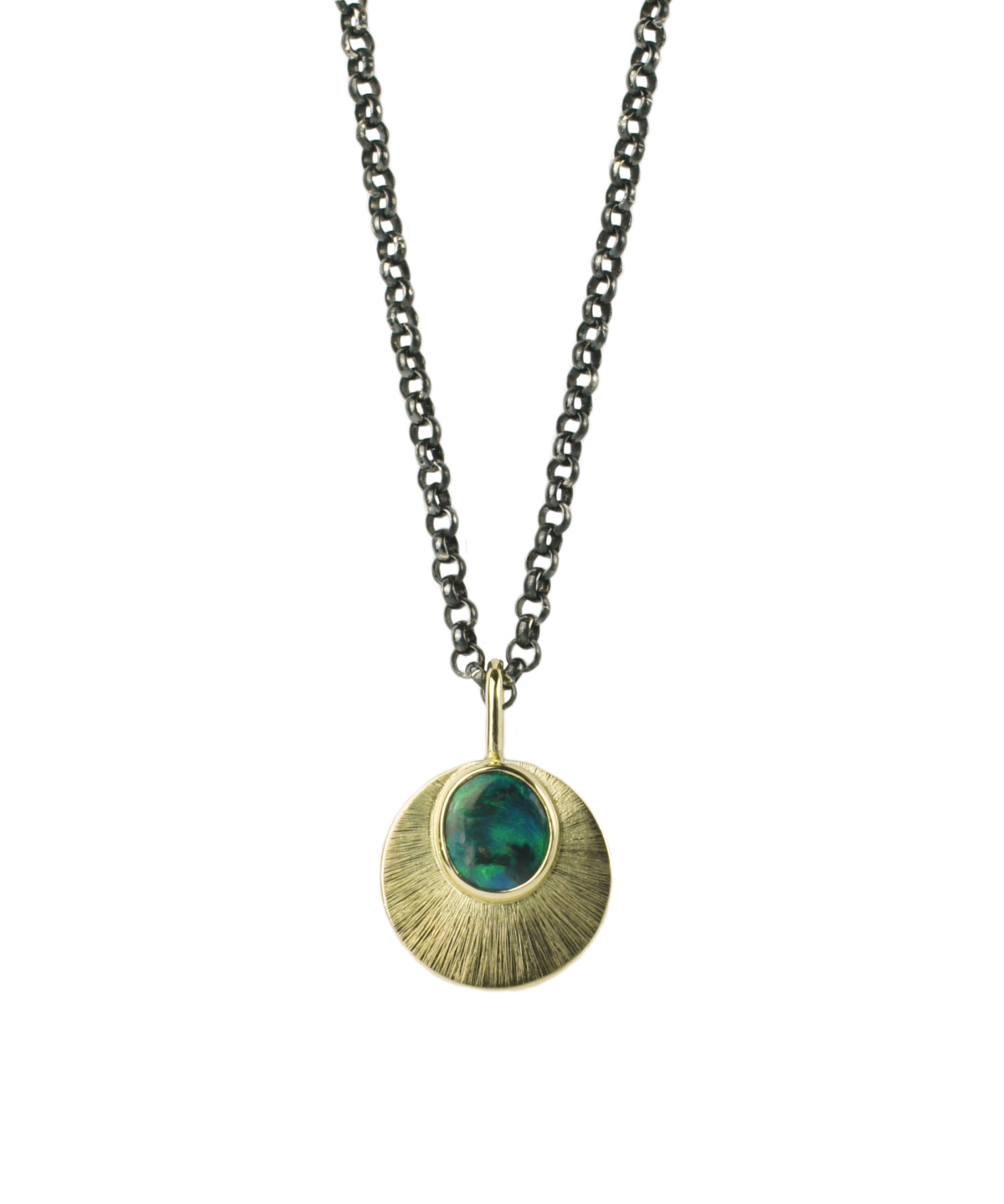 Australian Black Opal and 9ct Yellow gold pendant on an oxidised sterling silver chain, hangs on a white background. the Gold pendant is reminiscent of a moon and has an intricate engraved detail.
