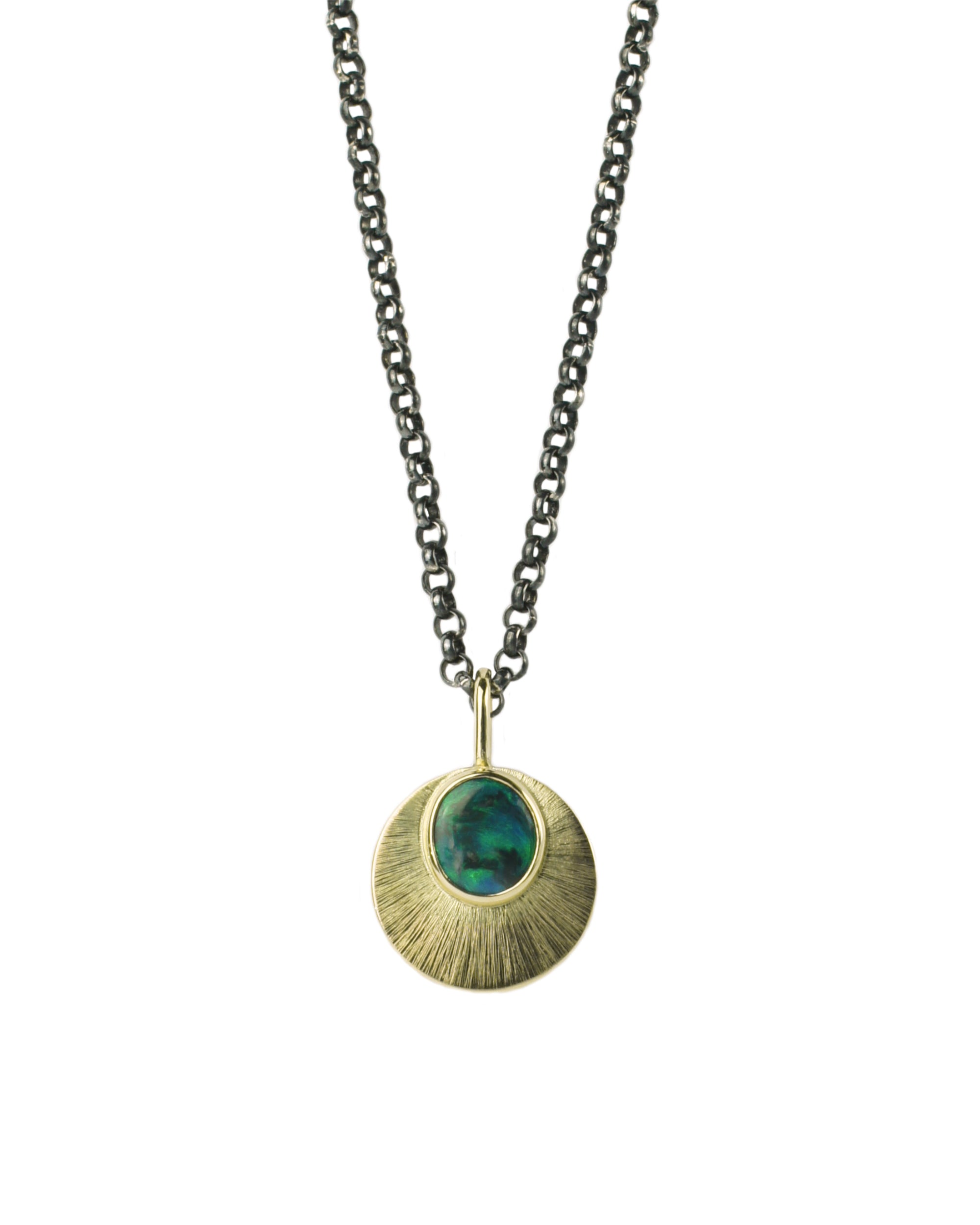 Australian Black Opal and 9ct Yellow gold pendant on an oxidised sterling silver chain, hangs on a white background. the Gold pendant is reminiscent of a moon and has an intricate engraved detail.
