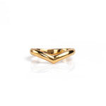 A polished gold wedding ring with a wide, open chevron or V-shaped design, displayed on a clean white reflective surface. Handmade by Emily Eliza Arlotte in Hobart, Tasmania.