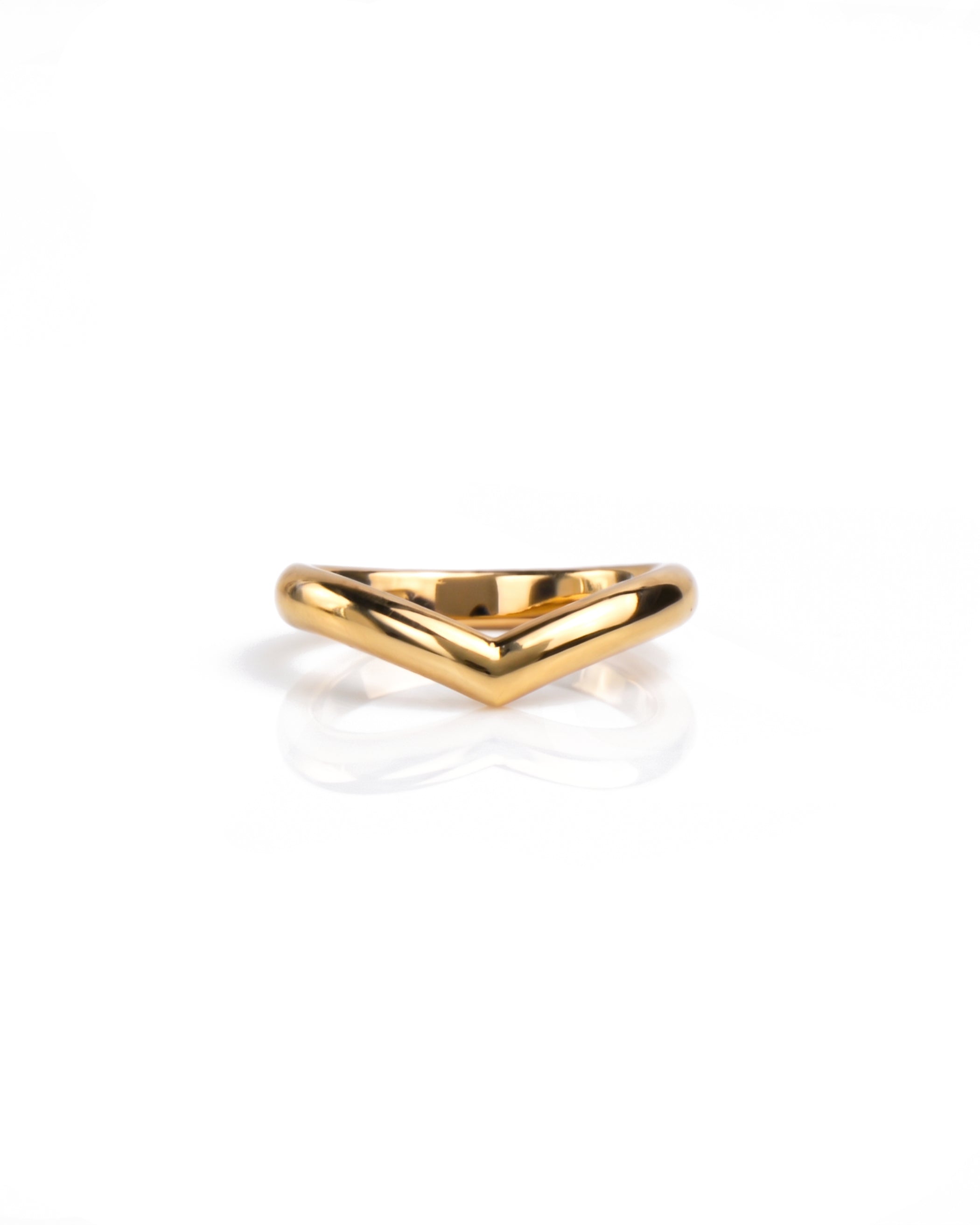 A polished gold wedding ring with a wide, open chevron or V-shaped design, displayed on a clean white reflective surface. Handmade by Emily Eliza Arlotte in Hobart, Tasmania.