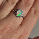 Close-up video of The Silver Aura Stained Glass Opal Silver Ring worn in the sun, capturing the shifting play of colours in the Crystal Opal against the Sterling Silver band.