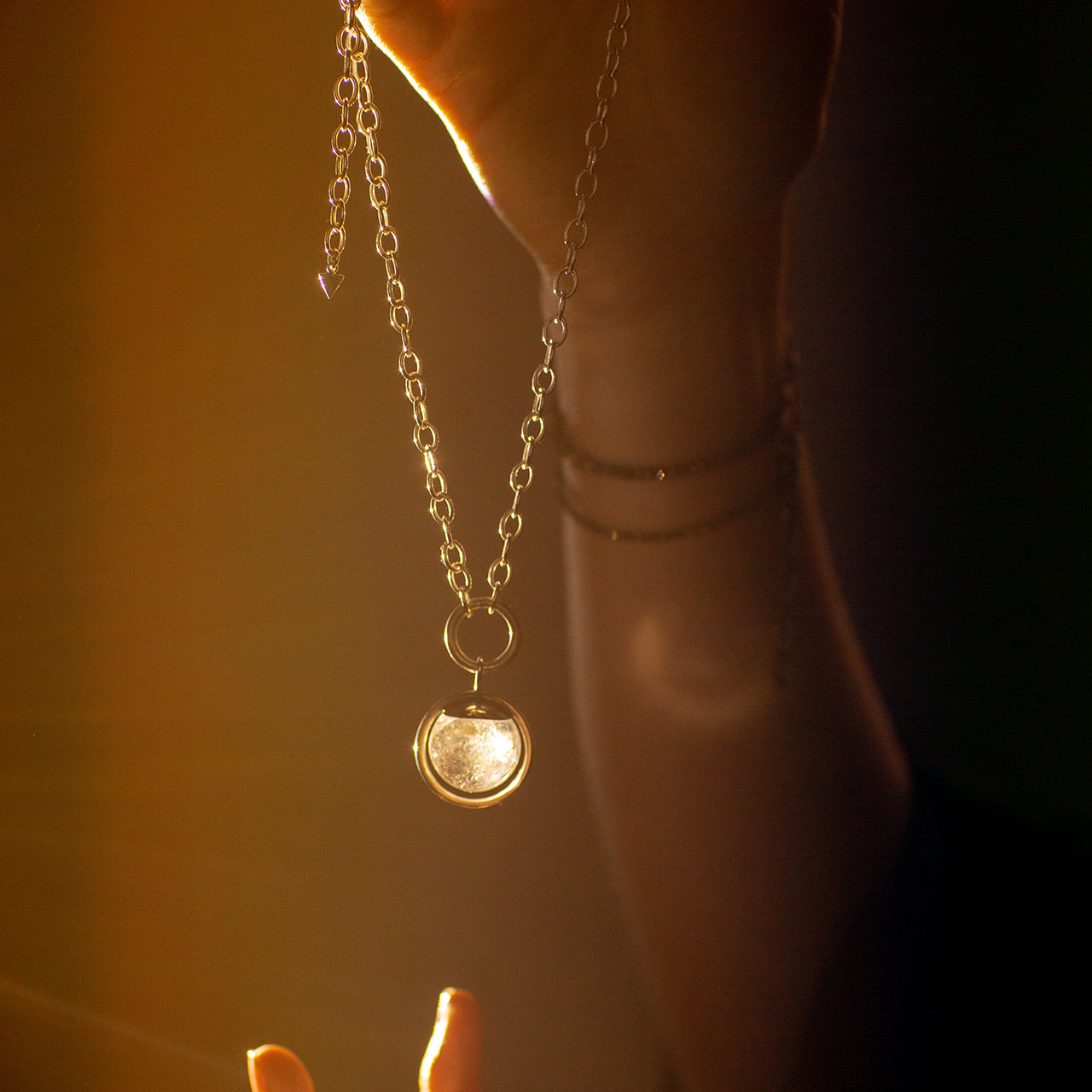 Emily Eliza Arlotte Handcrafted Fine Jewellery Magical Image of Hands Holding Sterling Silver Handmade Necklace with Crystal Ball Fortune Teller Vibes Mystical Boho Witchy Chunky Chain Made in Tasmania Australia Photography by Cassie Sullivan