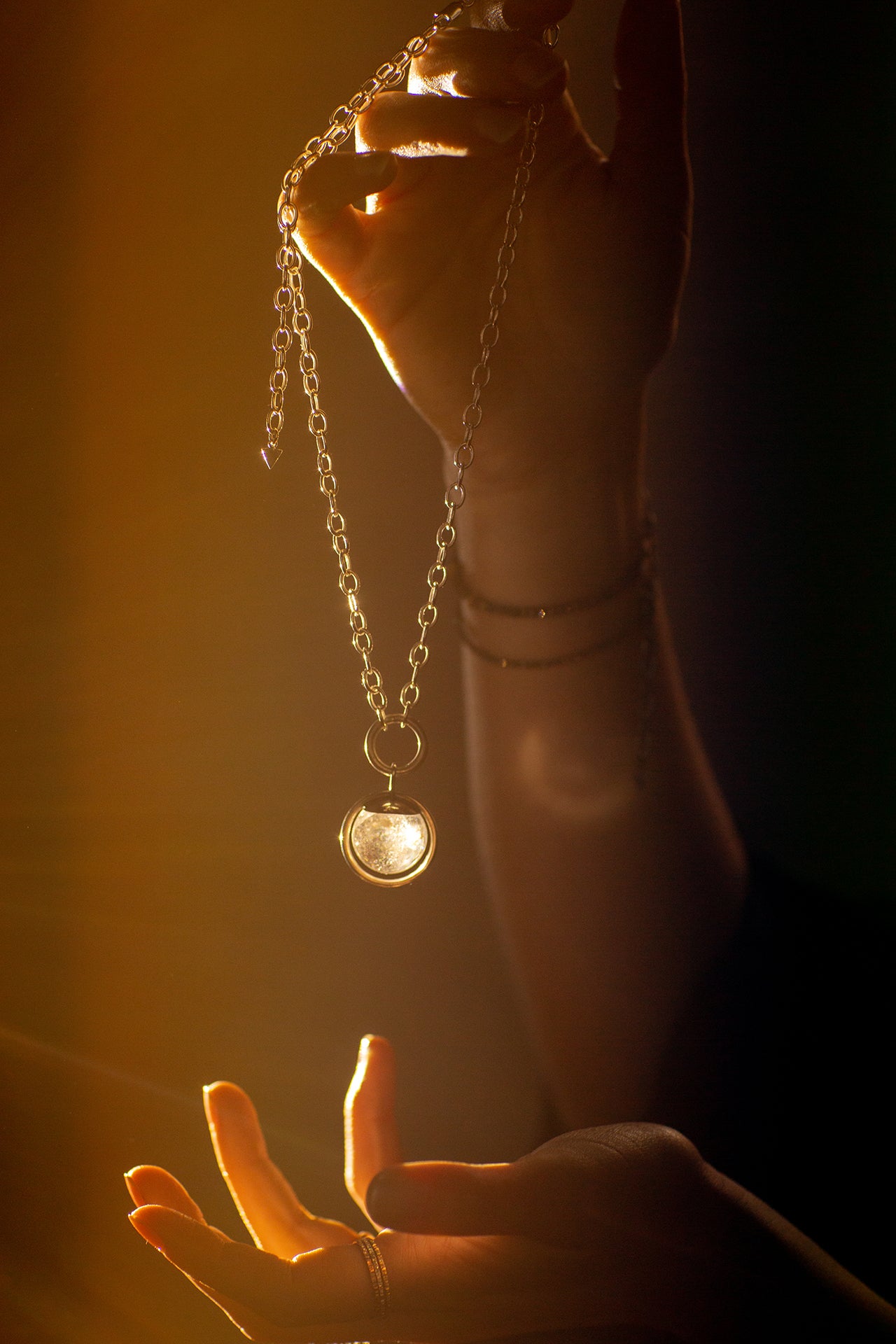 Emily Eliza Arlotte Handcrafted Fine Jewellery Magical Image of Hands Holding Sterling Silver Handmade Necklace with Crystal Ball Fortune Teller Vibes Mystical Boho Witchy Chunky Chain Made in Tasmania Australia Photography by Cassie Sullivan
