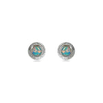 A pair of handmade opal stud earrings by Emily Eliza Arlotte, featuring mint green blue opals and an engraved textured halo, on a white background.