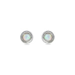 A pair of handmade opal stud earrings by Emily Eliza Arlotte, featuring white opals and an engraved textured halo, on a white background.