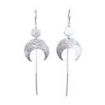 Lunar Thread Earrings on a white background. These sterling silver earrings feature a textured disc and crescent moon hanging from a hook and fine chain fitting.