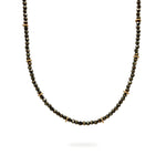 A beaded Pyrite and 9ct Gold choker necklace hangs on a white background. It has a blackened sterling silver chain. Handmade by Emily Eliza Arlotte Handcrafted Fine Jewellery in Hobart, Tasmania Australia.