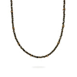 A beaded Pyrite and 9ct Gold choker necklace hangs on a white background. It has a blackened sterling silver chain. Handmade by Emily Eliza Arlotte Handcrafted Fine Jewellery in Hobart, Tasmania Australia.