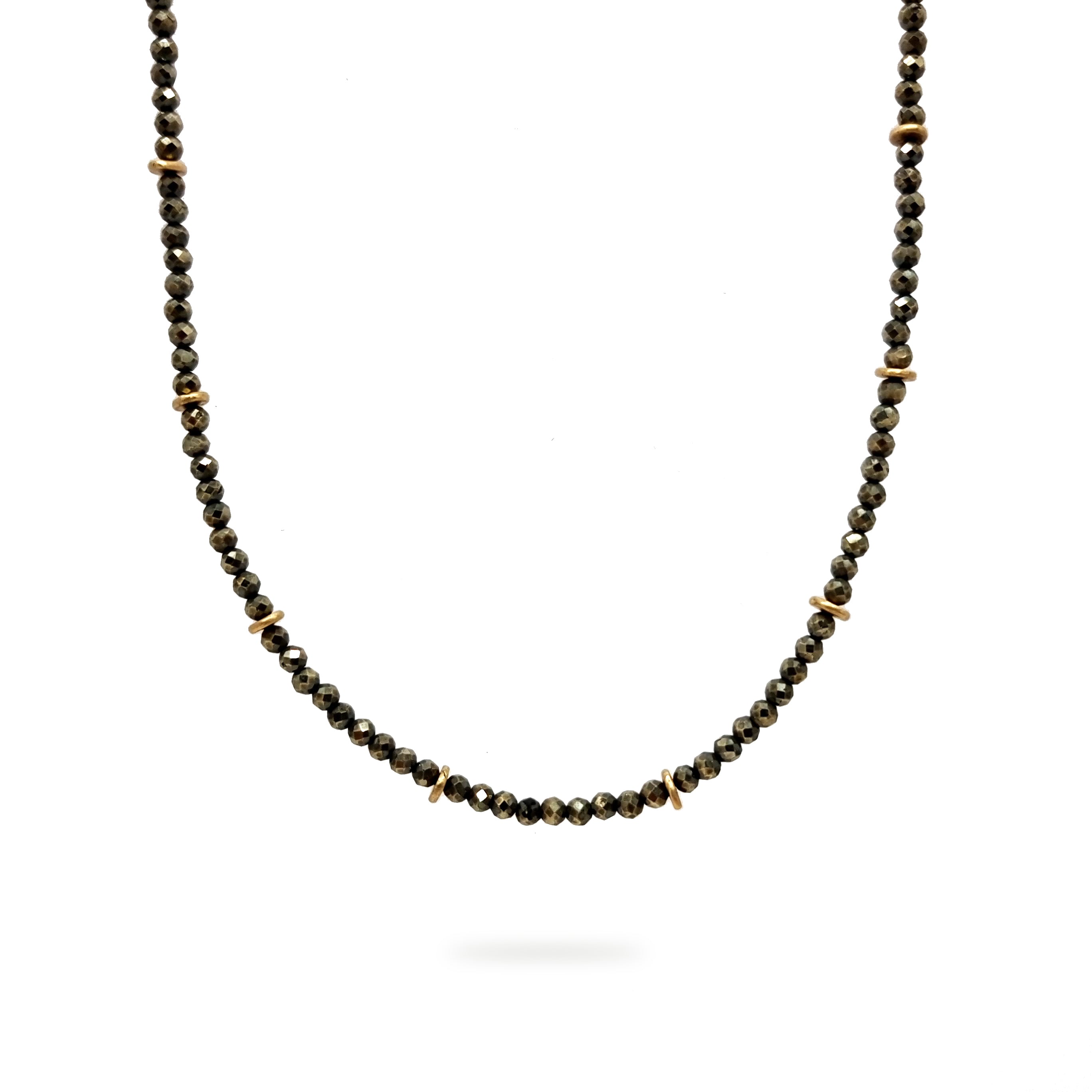 A beaded Pyrite and 9ct Gold choker necklace hangs on a white background. It has a blackened sterling silver chain. Handmade by Emily Eliza Arlotte Handcrafted Fine Jewellery in Hobart, Tasmania Australia.