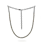 A beaded Pyrite and 9ct Gold choker necklace hangs on a white background. It has a blackened sterling silver chain. Handmade by Emily Eliza Arlotte Handcrafted Fine Jewellery in Hobart, Tasmania Australia.