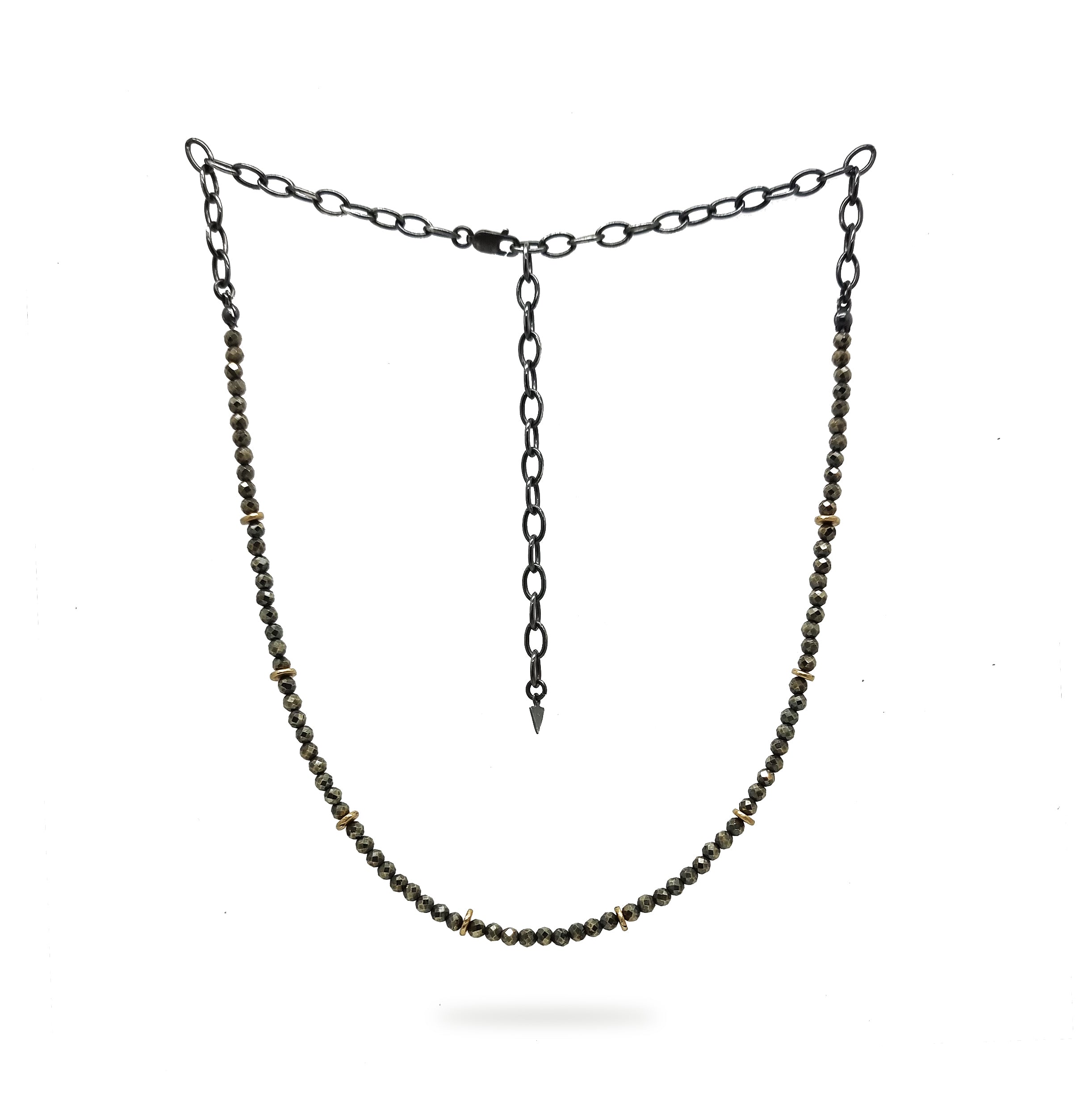 A beaded Pyrite and 9ct Gold choker necklace hangs on a white background. It has a blackened sterling silver chain. Handmade by Emily Eliza Arlotte Handcrafted Fine Jewellery in Hobart, Tasmania Australia.