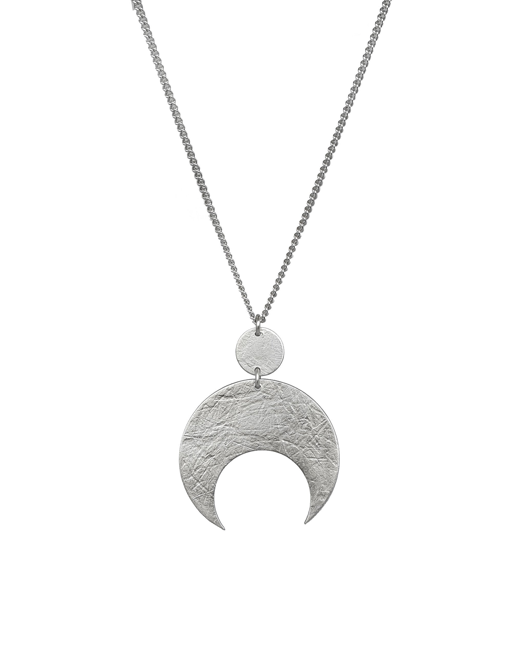 A crescent moon sterling silver necklace hangs on a white background. The silver moon and circle above it are textured and are handmade by Emily Eliza Arlotte in Hobart, Tasmania.