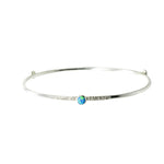 A Sterling Silver Blue Opal Bangle with a textured finish sits on a white background.